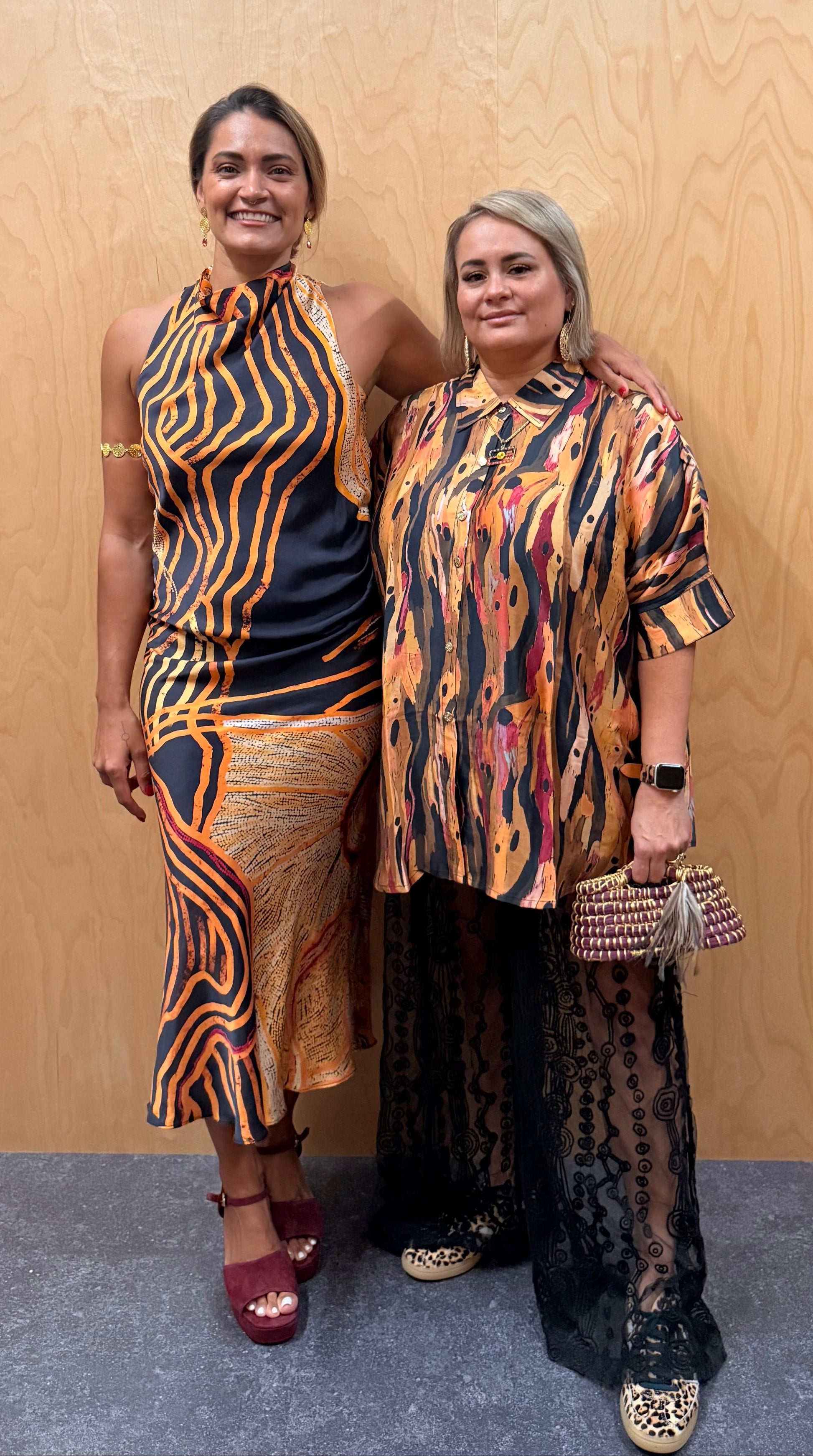 Two Aboriginal women in First Nations designed clothing