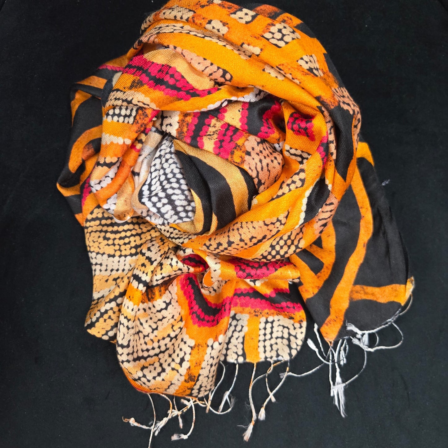 orange, black and red Aboriginal art by Sarrita King on a mulberry silk scarf
