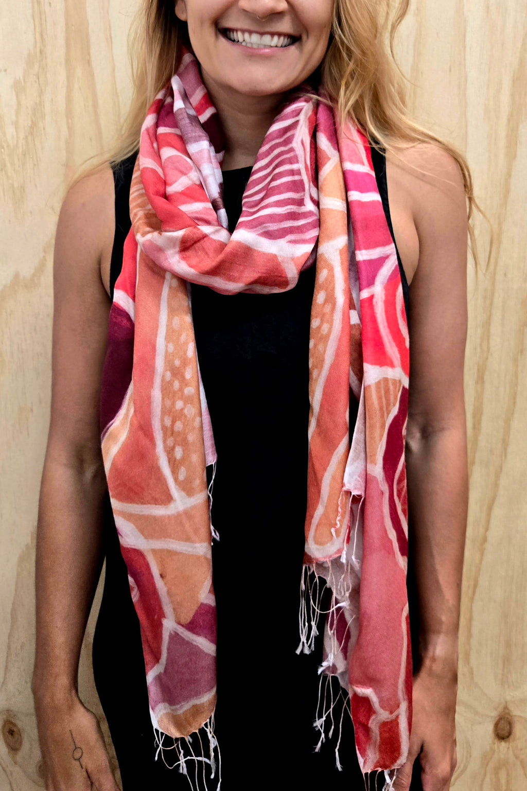 An Aboriginal woman wearing a Aboriginal artwork scarf in mulberry silk