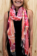 An Aboriginal woman wearing a Aboriginal artwork scarf in mulberry silk
