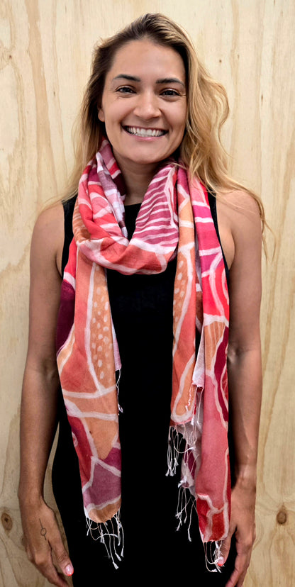An Aboriginal woman wearing a Aboriginal artwork scarf in mulberry silk