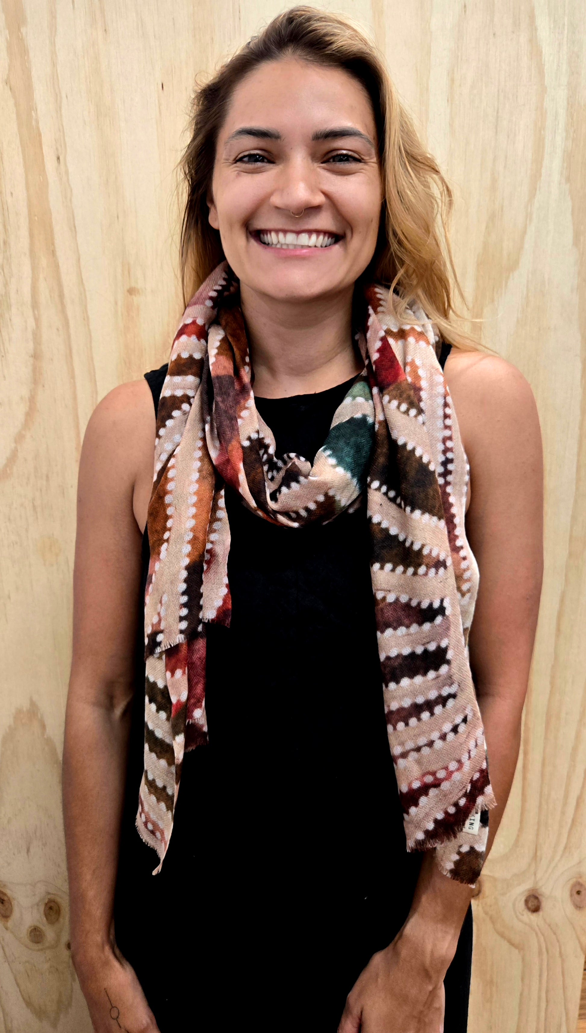 An Aboriginal woman wearing a Aboriginal artwork scarf in cashmere wool
