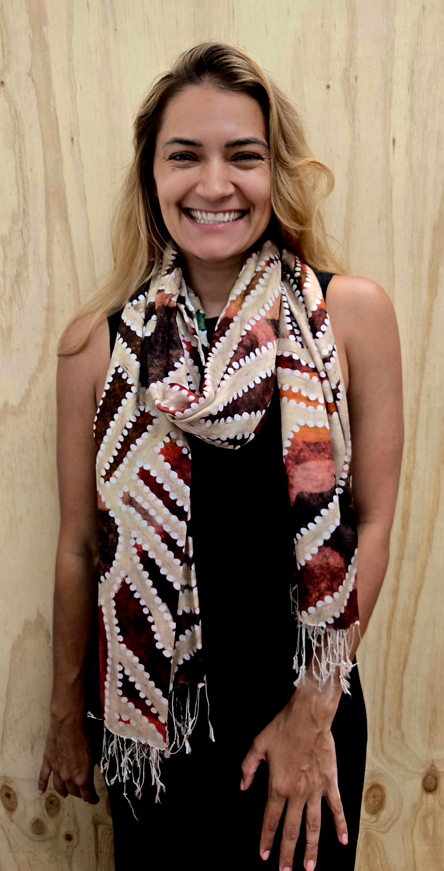 An Aboriginal woman wearing a Aboriginal artwork scarf in mulberry silk