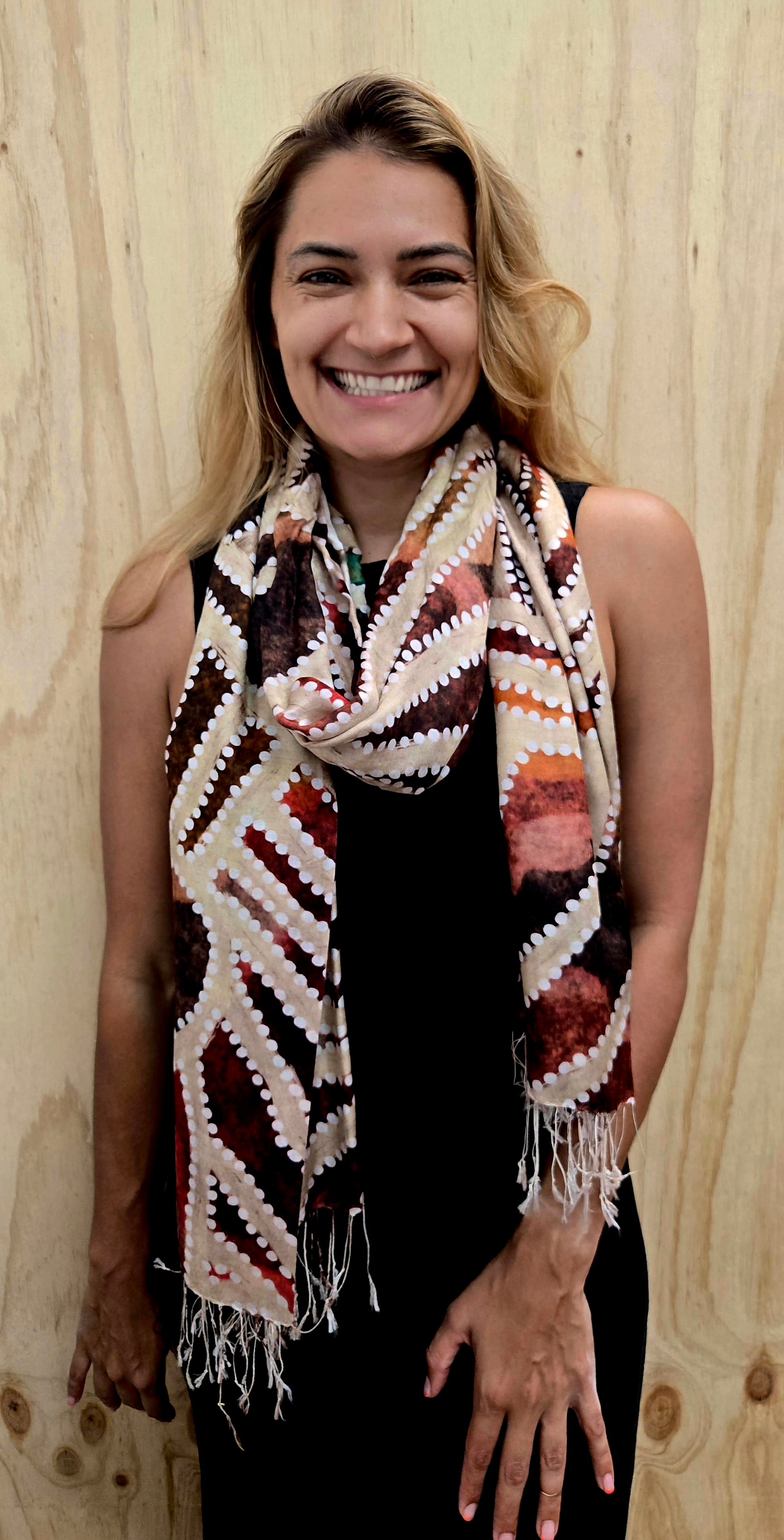 An Aboriginal woman wearing a Aboriginal artwork scarf in mulberry silk